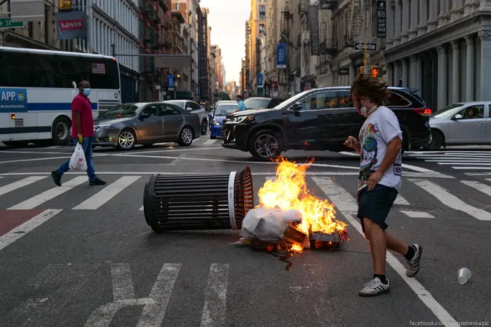 A photo of a runner avoiding a garbage can on fire